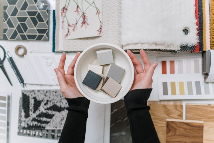 Woman Hands Holding Decorative Samples In Bowl