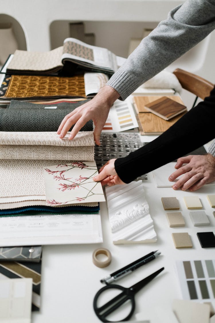 People Looking At Different Fabrics