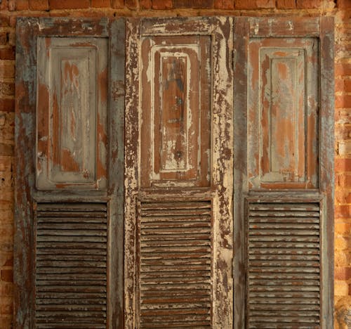 Free Old shutters with weathered surface on brick wall Stock Photo