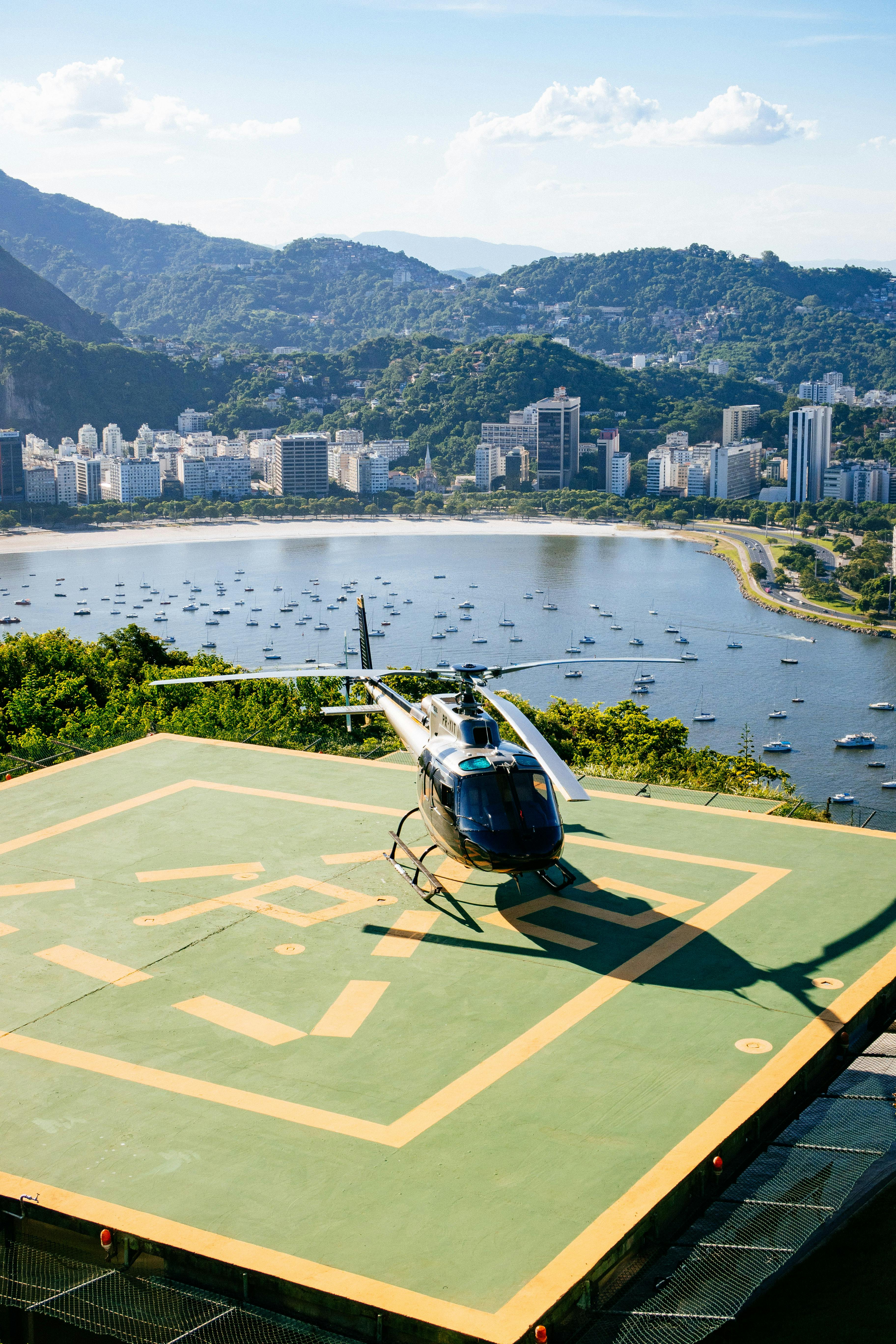 helicopter against sea and mountains under cloudy sky