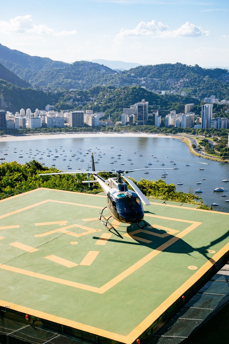 Helicopter Against Sea And Mountains Under Cloudy Sky