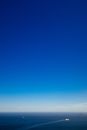 Ships sailing on sea under blue sky