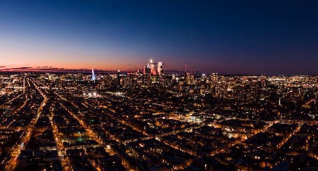 Stunning aerial view of Philadelphia skyline at twilight, showcasing vibrant city lights.
