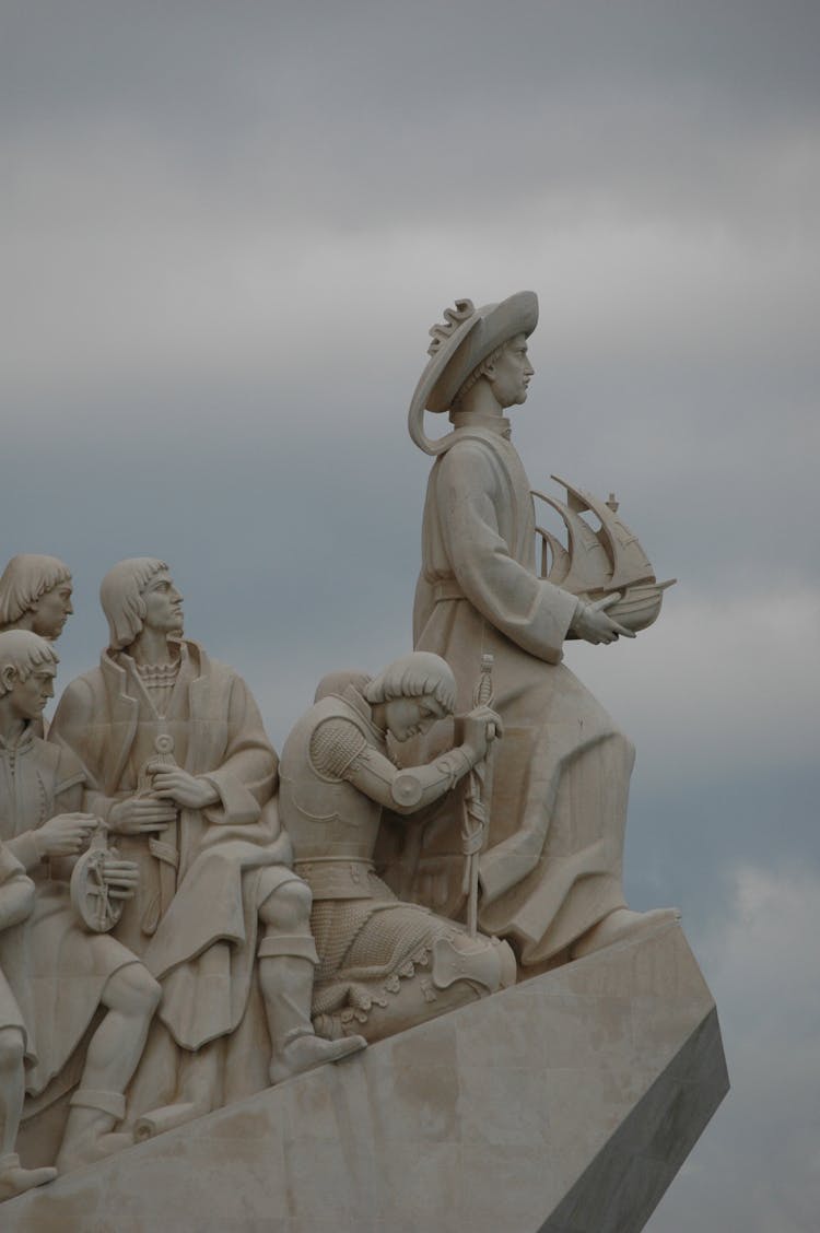 Concrete Statues Under White Clouds