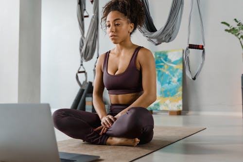 Woman with a Sports Bra Sitting Near a Laptop