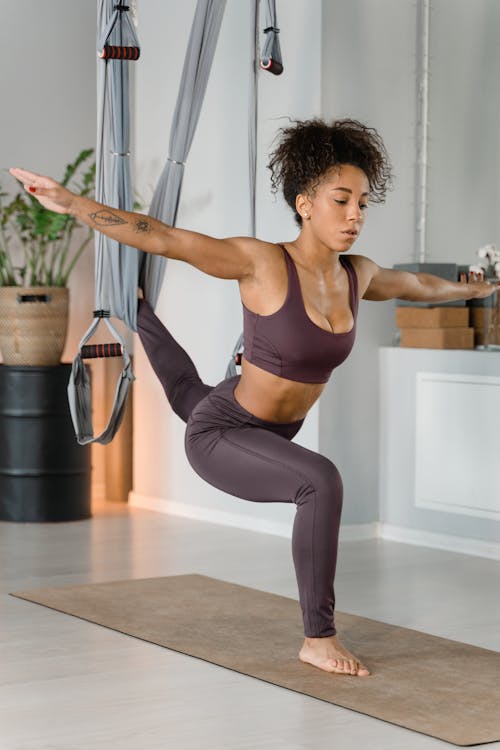 Photo of a Woman Exercising while Her Arms are Apart