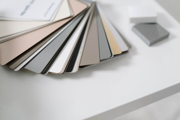 Neutral colour samples on a minimalist desk, by cottonbro studio on Pexels