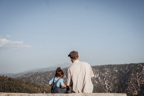 A Man and a Child Looking at the Mountain