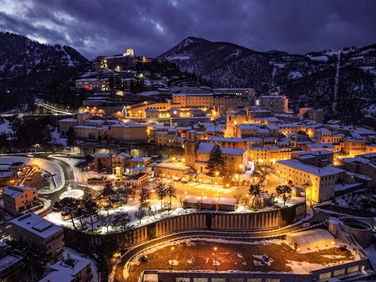 Snowy Small Town On Hillside At Night