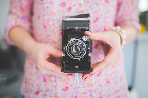 Old analog camera in woman's hands