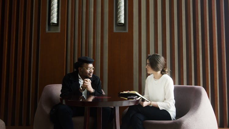 Man In Black Long Sleeve Shirt Sitting On A Chair