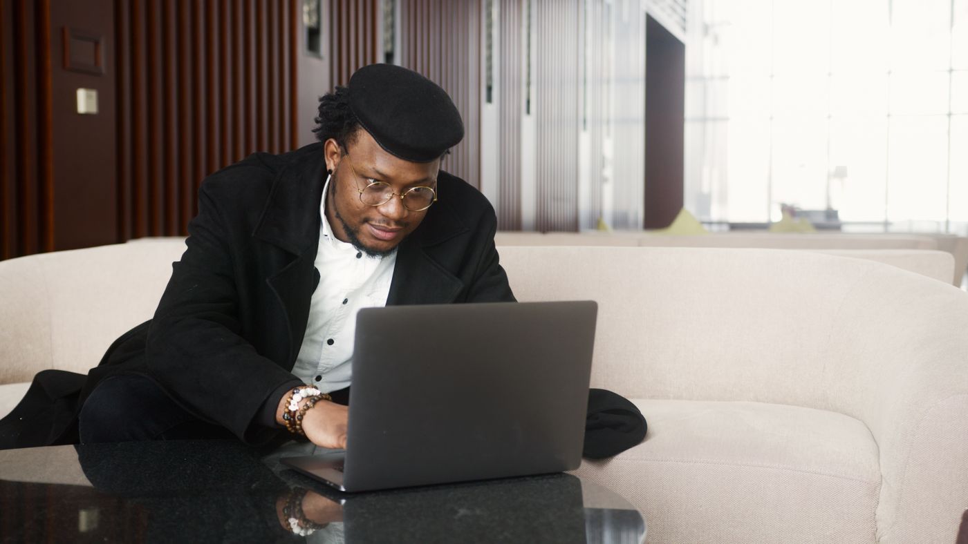A man concentrating on a laptop in an office