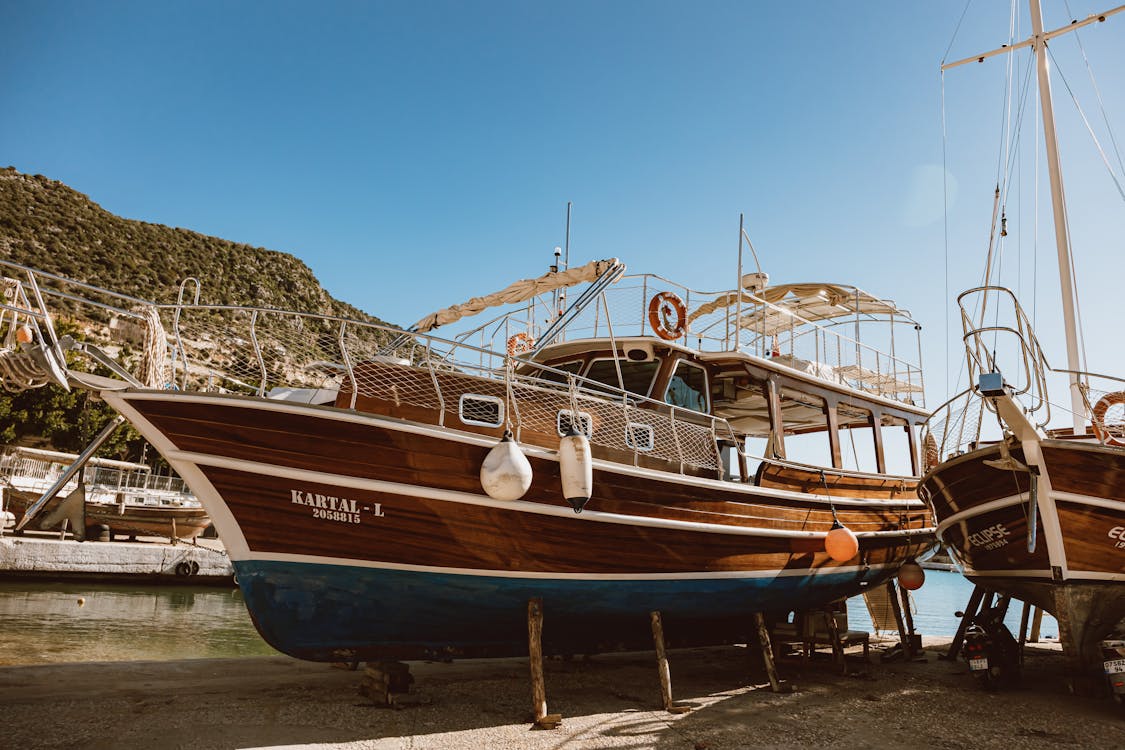 Blue and White Boat on Beach Shore