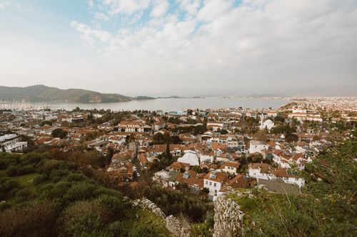 Free Aerial view of a beautiful coastal town surrounded by hills and water, showcasing architecture and nature. Stock Photo