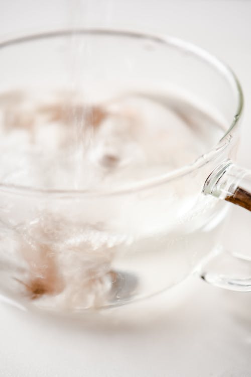 A Close-Up Shot of a Glass Cup being Filled with Water