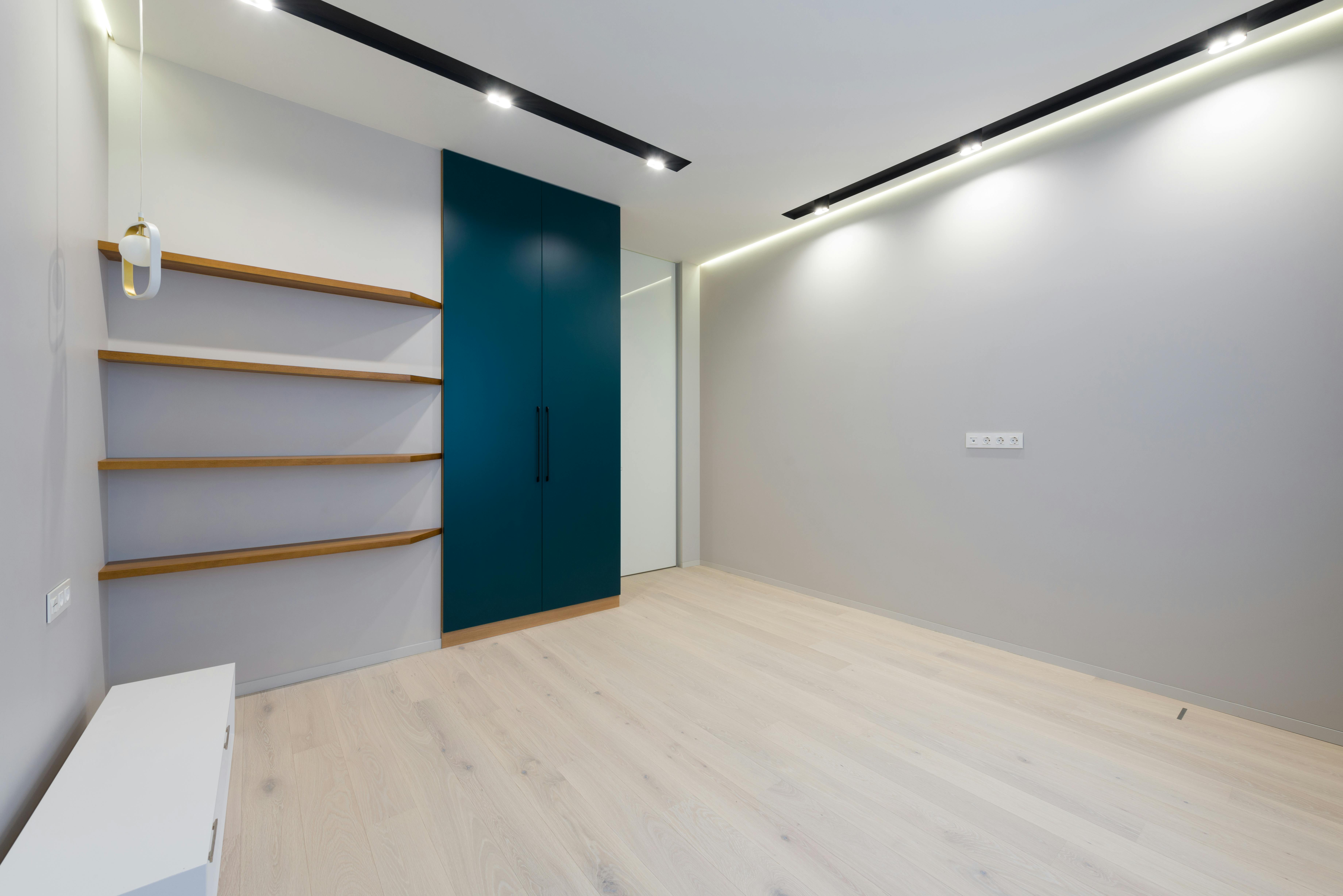 interior of spacious room with wooden furniture and laminate floor