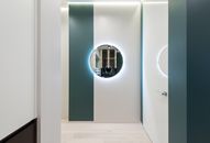 Hall of contemporary apartment with round mirror