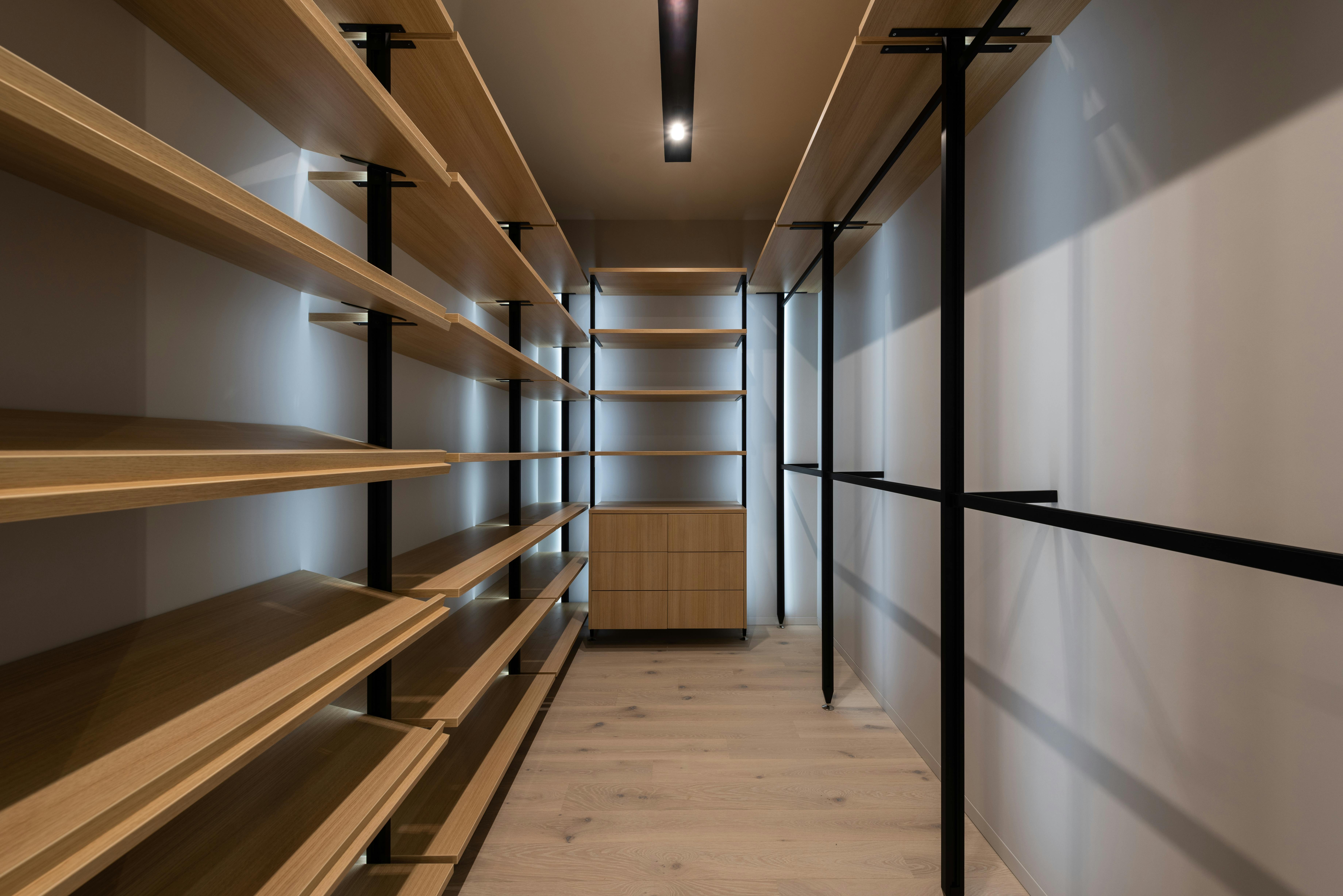 Bright Empty Walk-in Closet With Wood Shelves, Beige Carpet Floor
