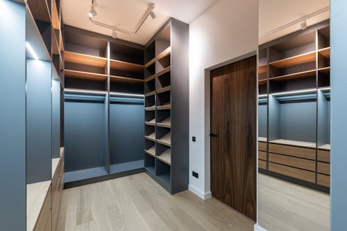 Wardrobe interior with shelves near door