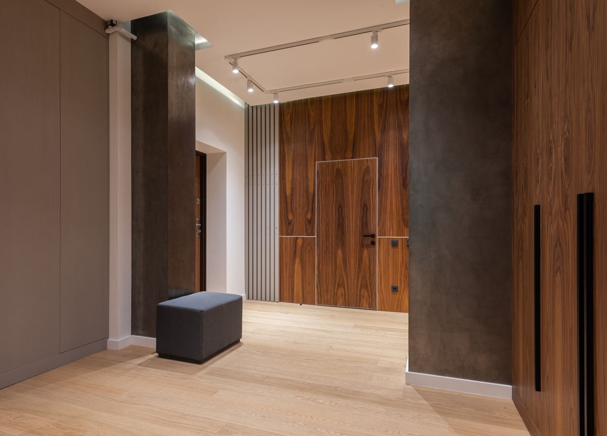 Bedroom with deep-colored board-and-batten style wall molding used as an accent wall behind a bed