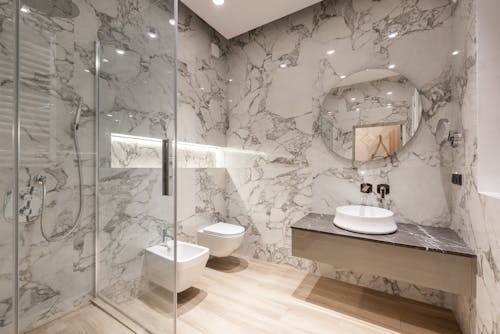 Bathroom interior with bidet and toilet near sink and shower
