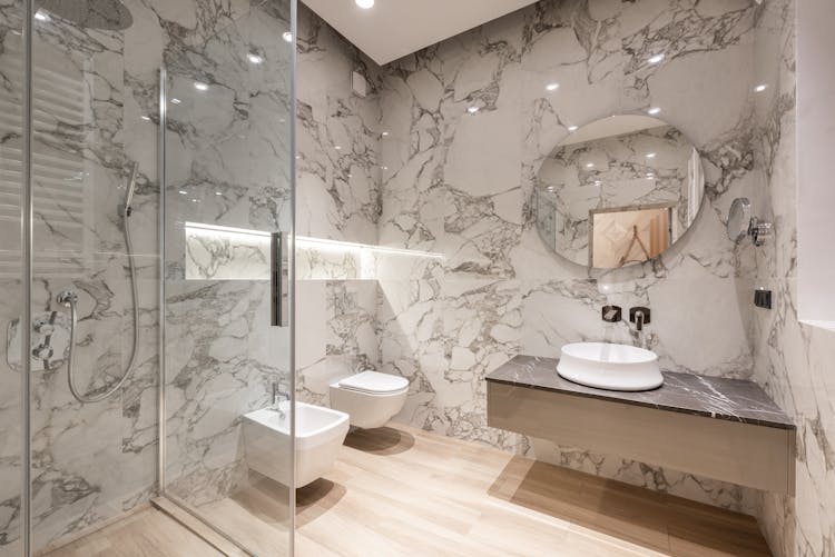 Bathroom Interior With Bidet And Toilet Near Sink And Shower