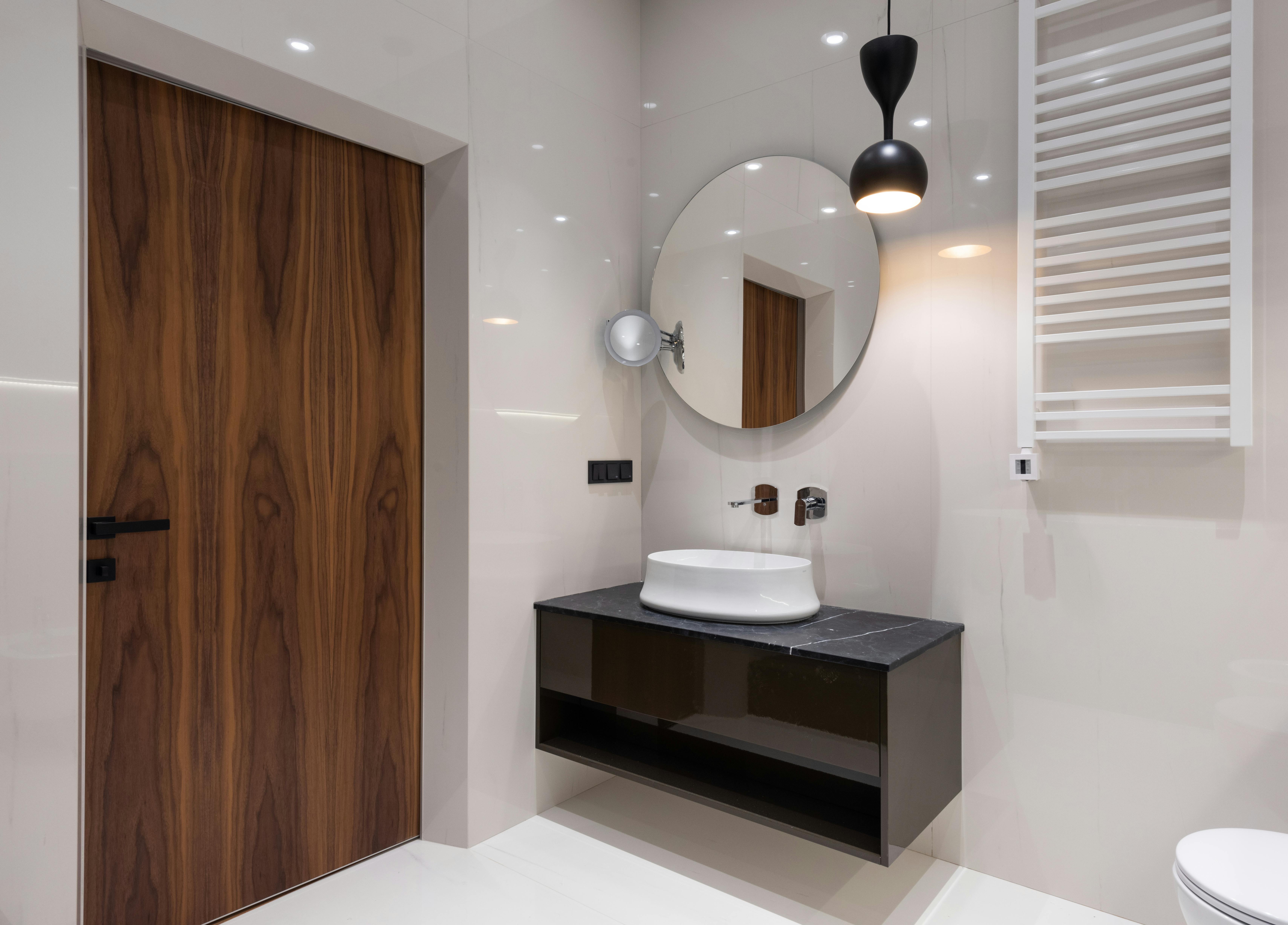 washroom interior with sink on cabinet near mirror