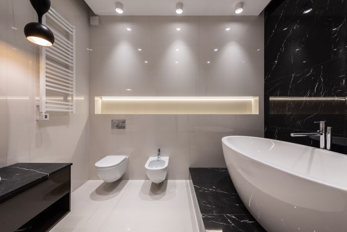 Freestanding tub in a black marble bathroom