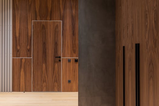 A modern corridor featuring sleek wooden paneling and minimalist design elements, ideal for home inspiration.