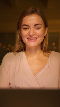 A cheerful woman enjoying her relaxing evening with a warm smile.