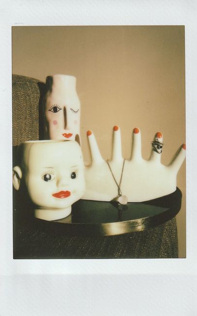 A stylish arrangement of unique ceramic vases and jewelry in an artistic display.