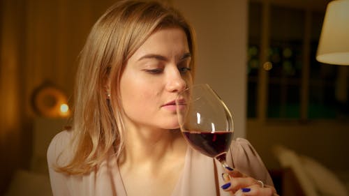 Close-Up Shot of a Pretty Woman Drinking a Glass of Wine