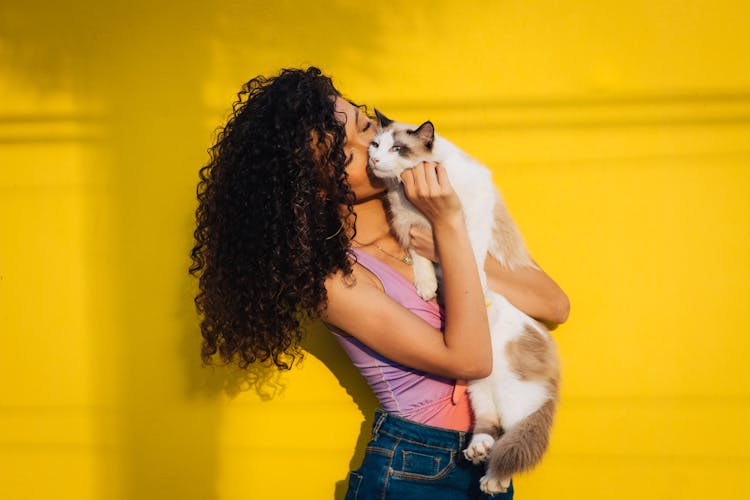 A Woman Kissing A Cat