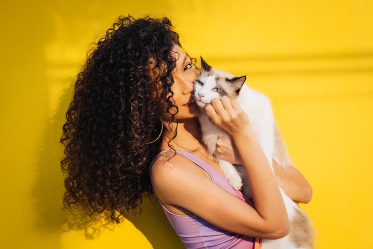 A Woman Hugging A Cat