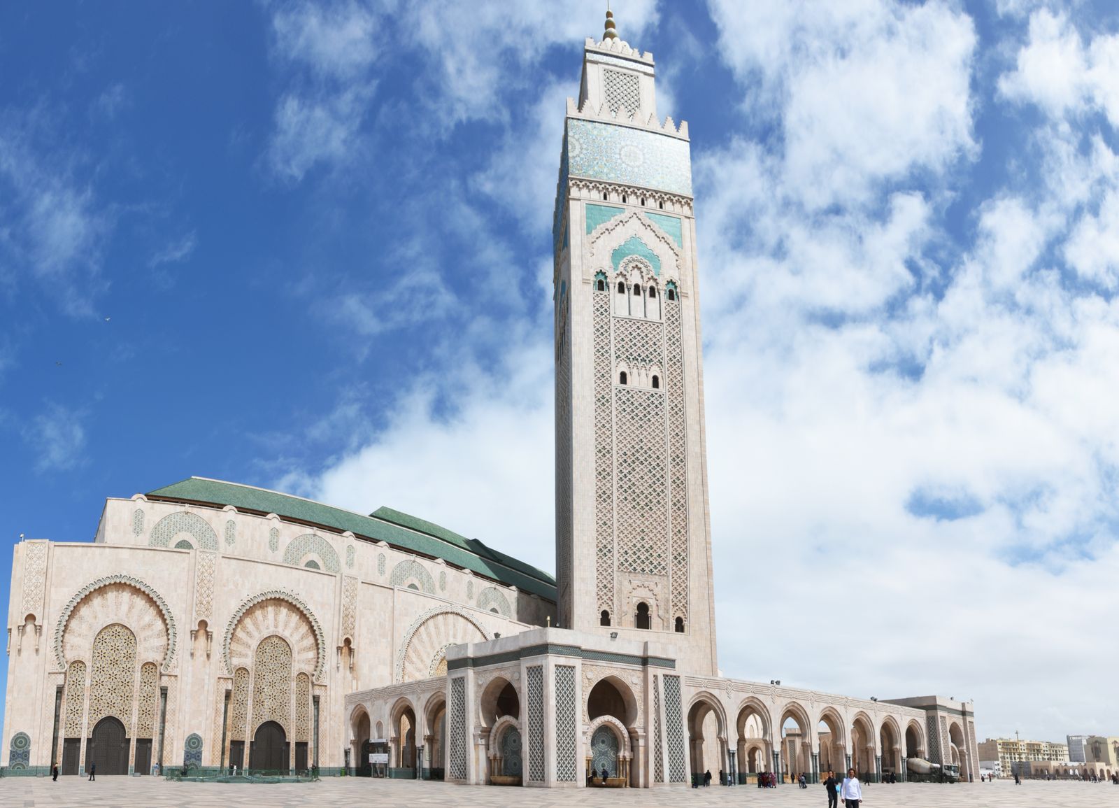 Best tours from Casablanca 2026 — guided group at the Hassan II Mosque with the Atlantic coast visible behind