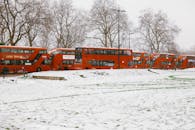 Red and White Concrete Building on Snow Covered Ground