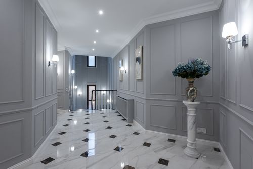 Free Gray walls and shiny marble floor in hallway of spacious classic styled villa decorated with paintings and lamps Stock Photo