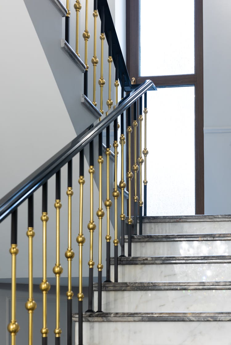 Staircase With Marble Steps And Metal Banister In House