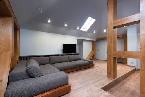 Large lounge with soft sofa under window on ceiling