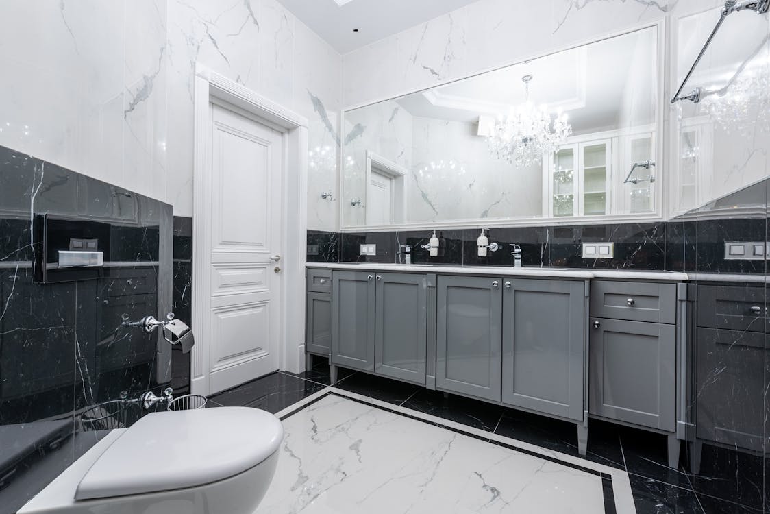 Free Prestige bathroom with large mirror and glowing chandelier Stock Photo