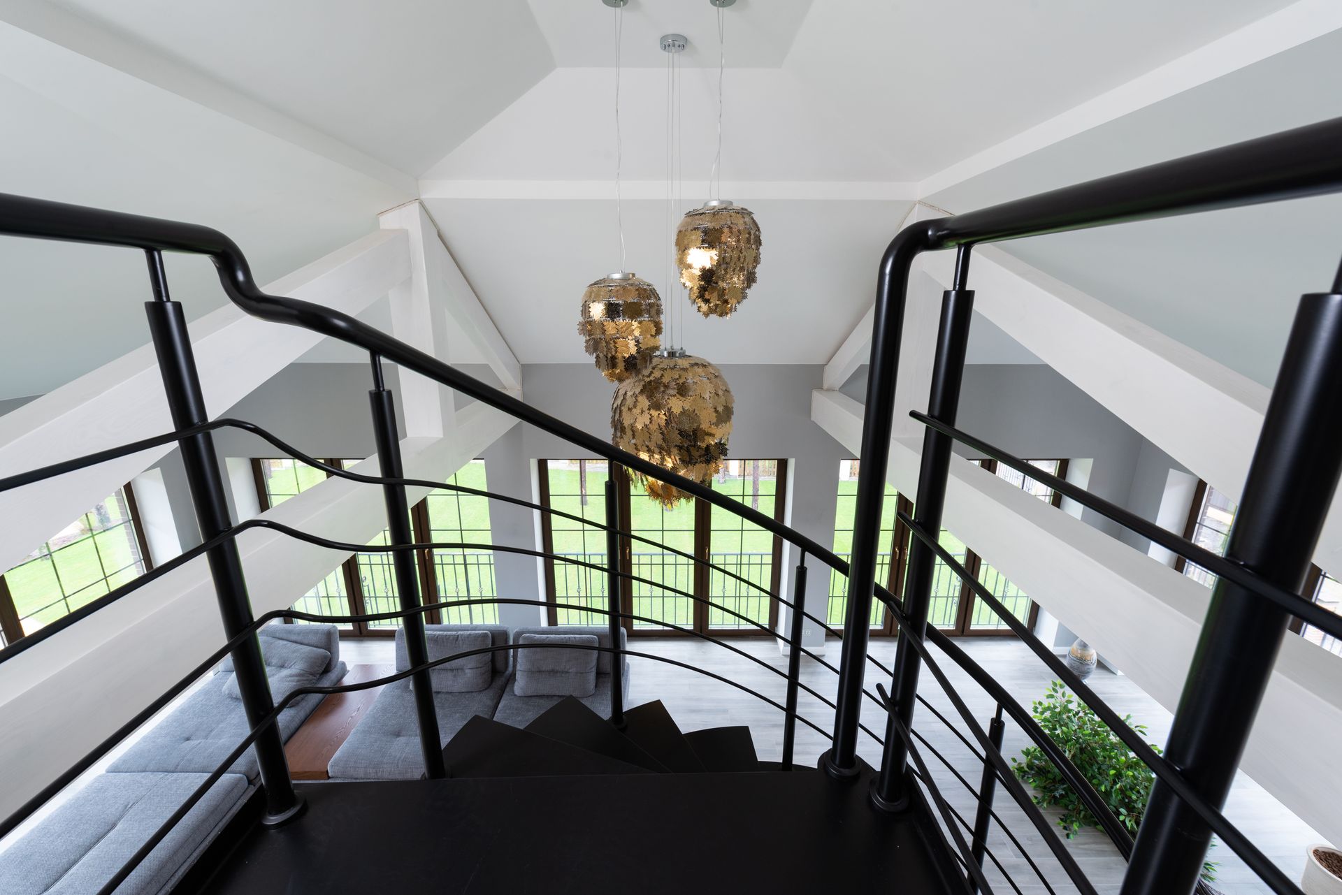 Modern loft interior featuring stylish pendant lighting and open staircase design.