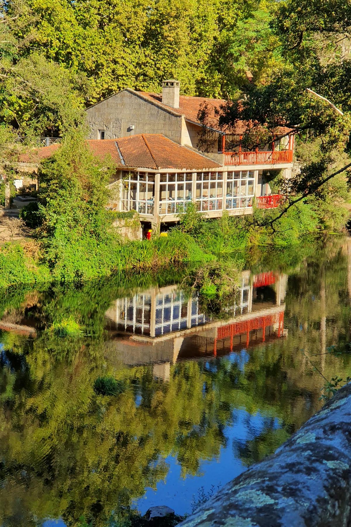 Bedroom with a painted arch accent wall behind a bed and minimalist decor