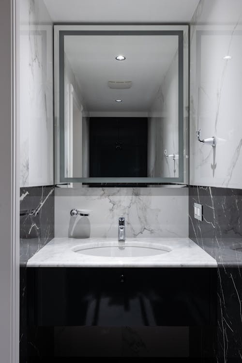 Stylish sink and mirror in bathroom
