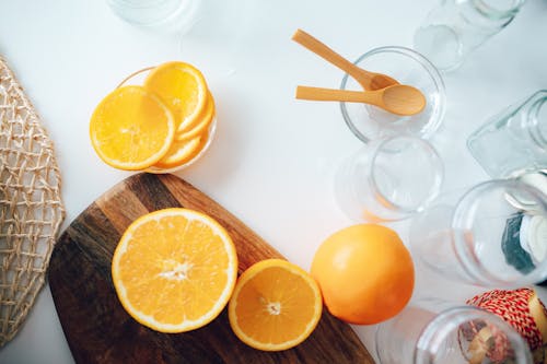 Sliced Orange on Brown Wooden Chopping Board