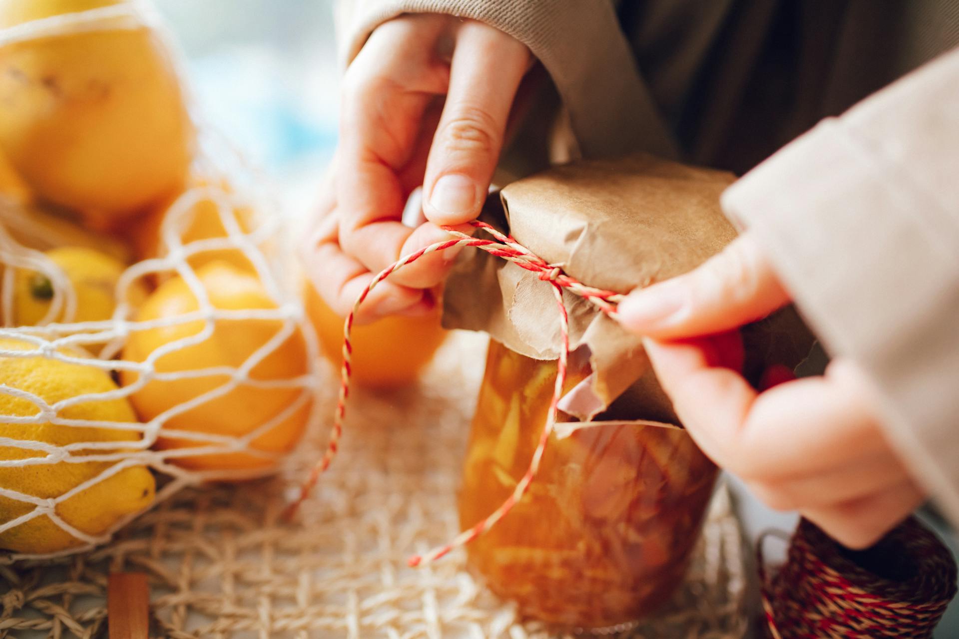 Woman Packing Homemade Jam in a Jar