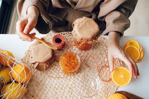 Free Top View of Woman Making Homemade Orange Jam  Stock Photo