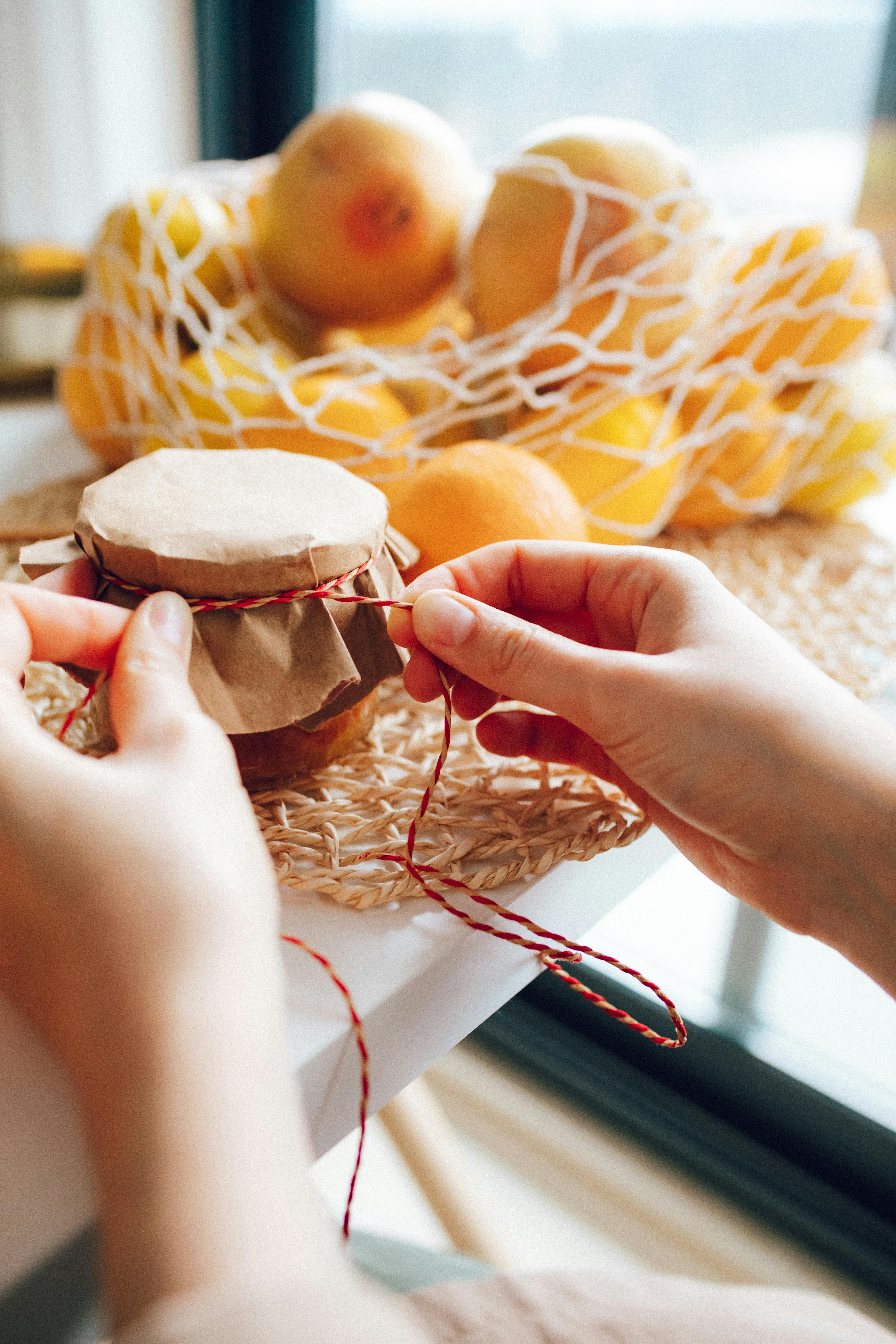 Hands Tying a Twine around a Jar · Free Stock Photo