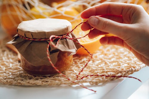 Free Close-up of a Woman Touching a Thread Attached to a Jar Stock Photo