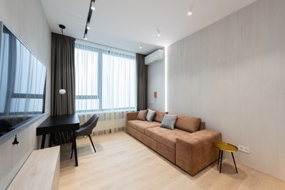Minimalist staged living room with sofa and curtains
