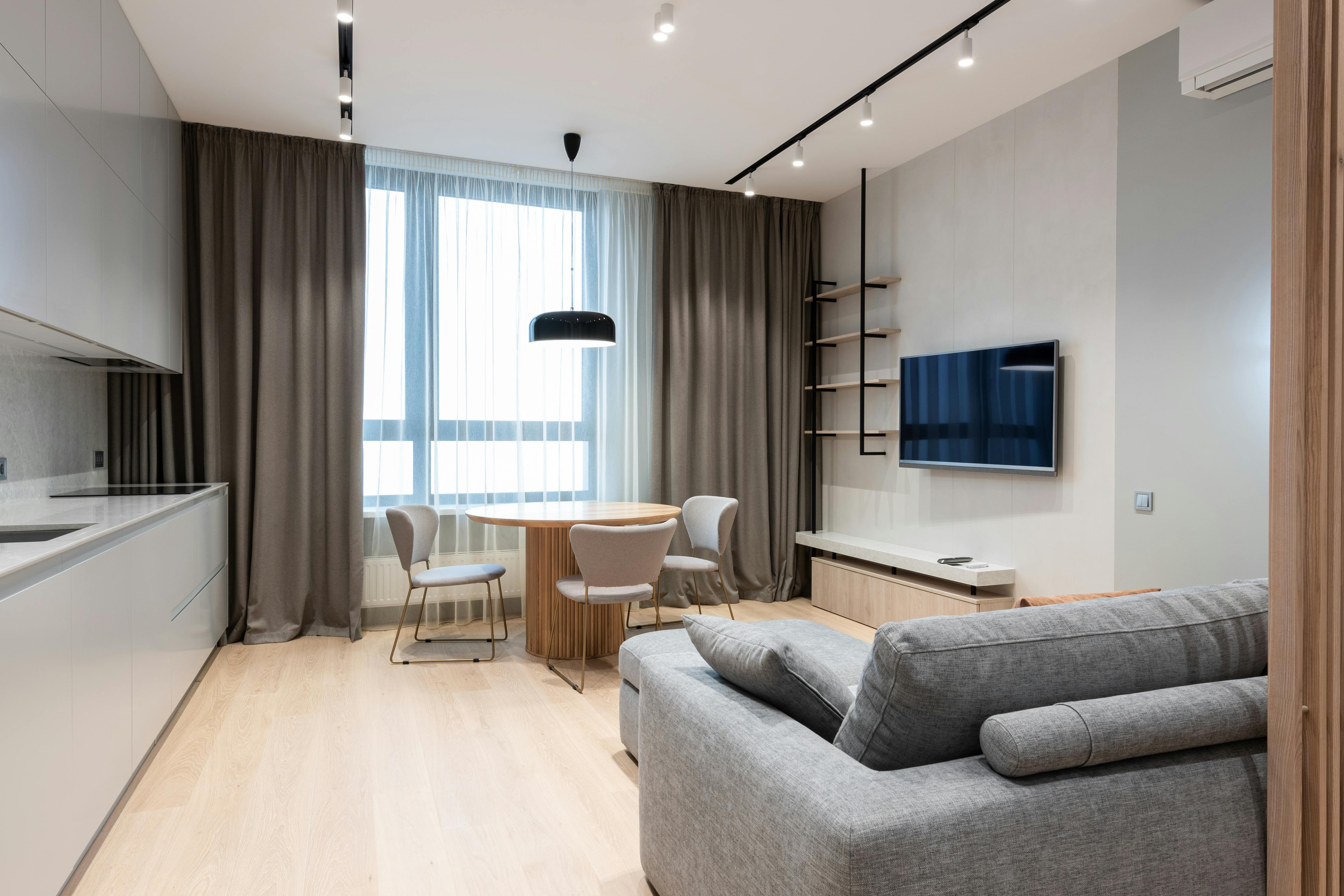 house interior with couch and table with chairs near kitchen